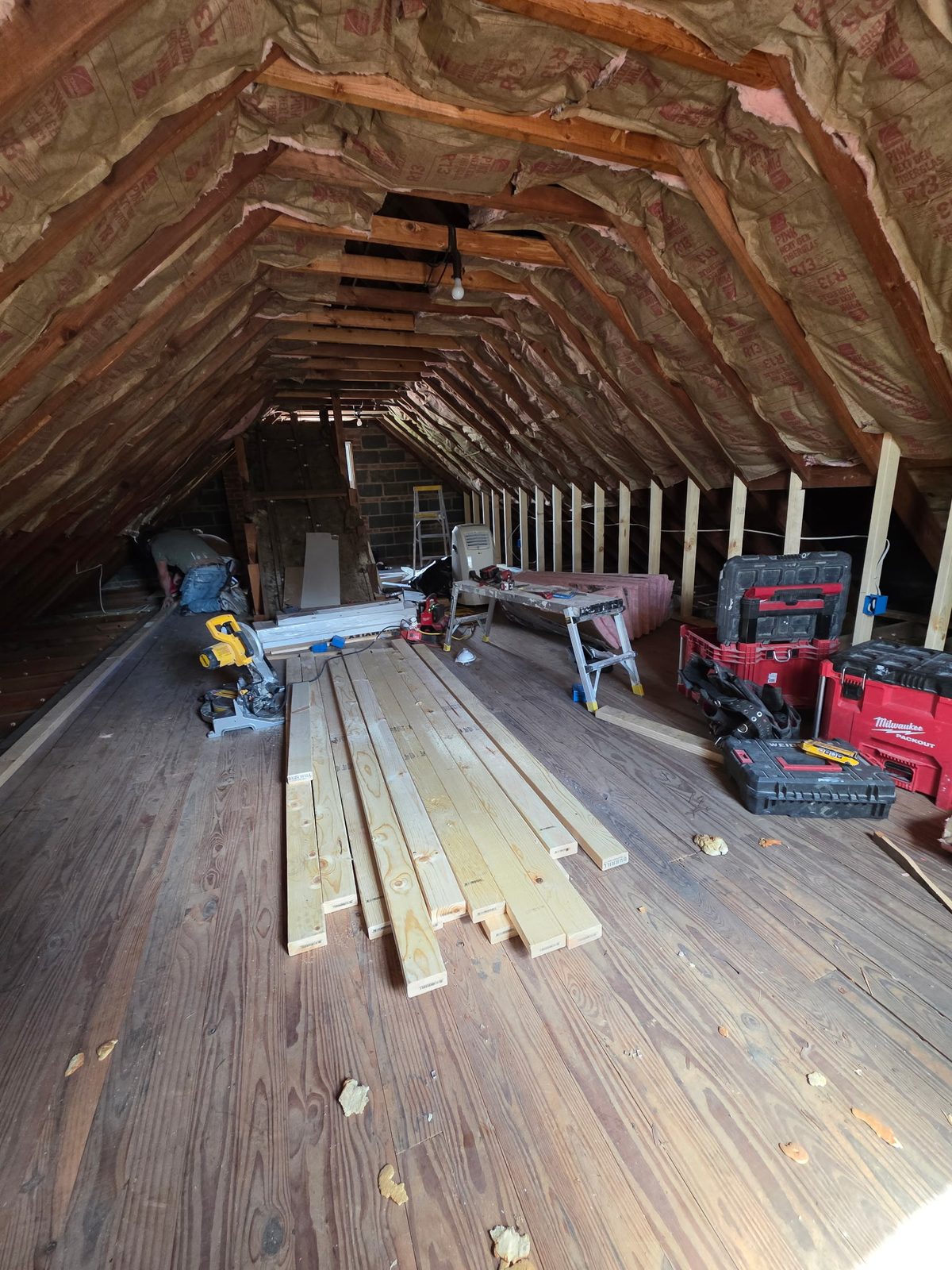 Attic room before flooring installation, subfloor and framing exposed