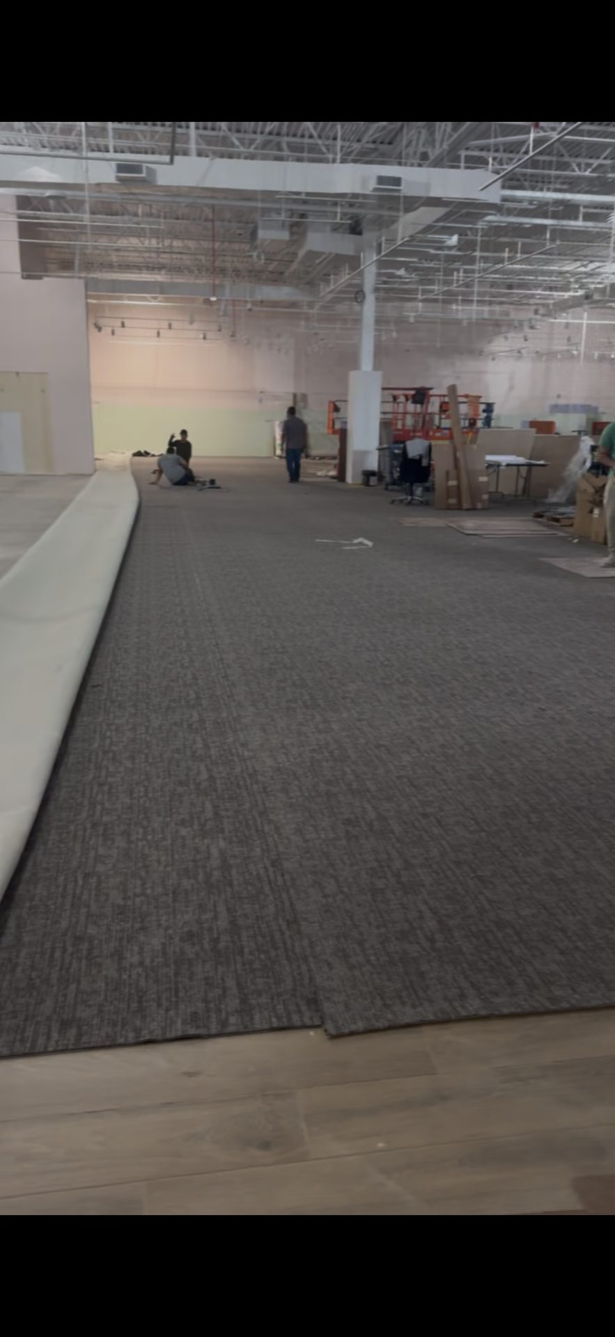 Commercial carpet tile being installed in a large retail space